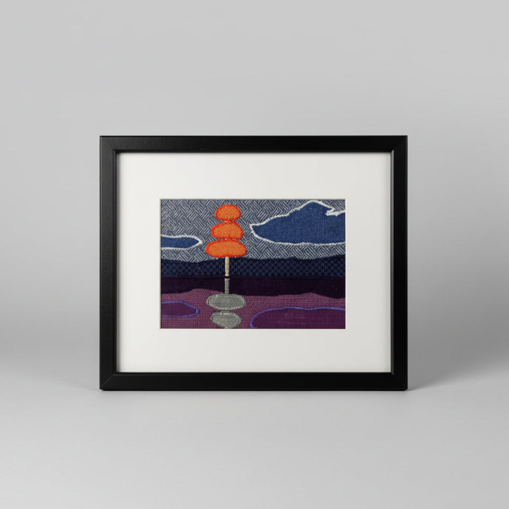 Framed fabric landscape scene with a stylised tree and lake