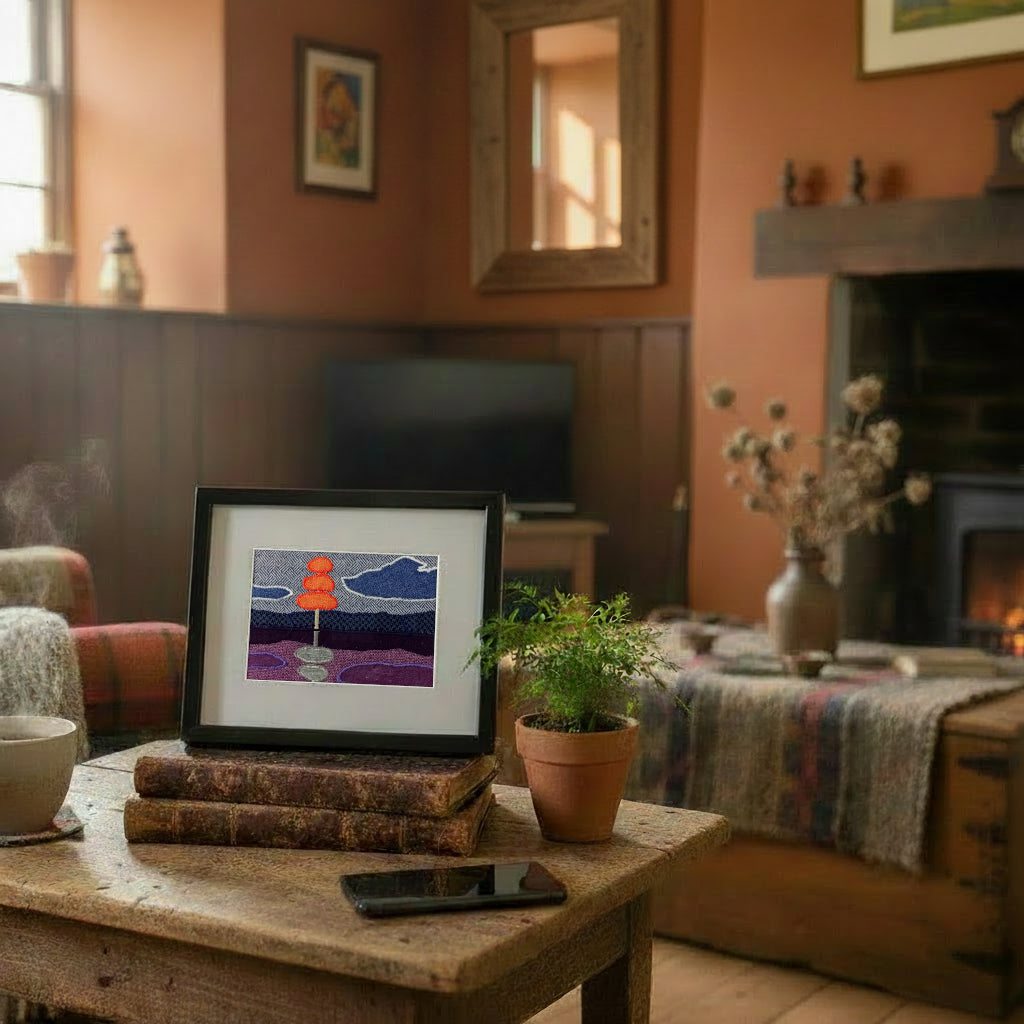 Framed fabric artwork sitting on a side table in a rustic country living room