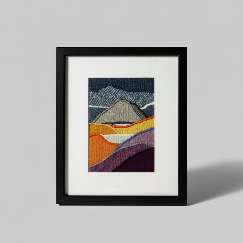 Framed fabric art with mountains and lakes scene
