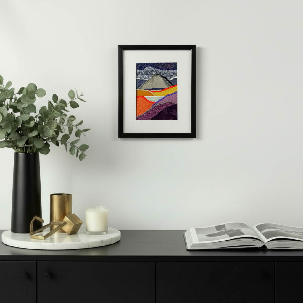 Framed fabric art with mountains and lakes scene