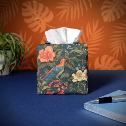 Square linen tissue box cover with a pen, notebook, and plant