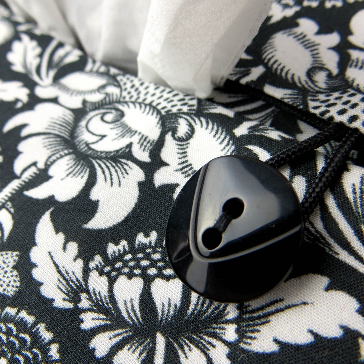 Rectangle tissue box cover with white flowering vine design on black background