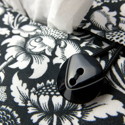 Rectangle tissue box cover with white flowering vine design on black background