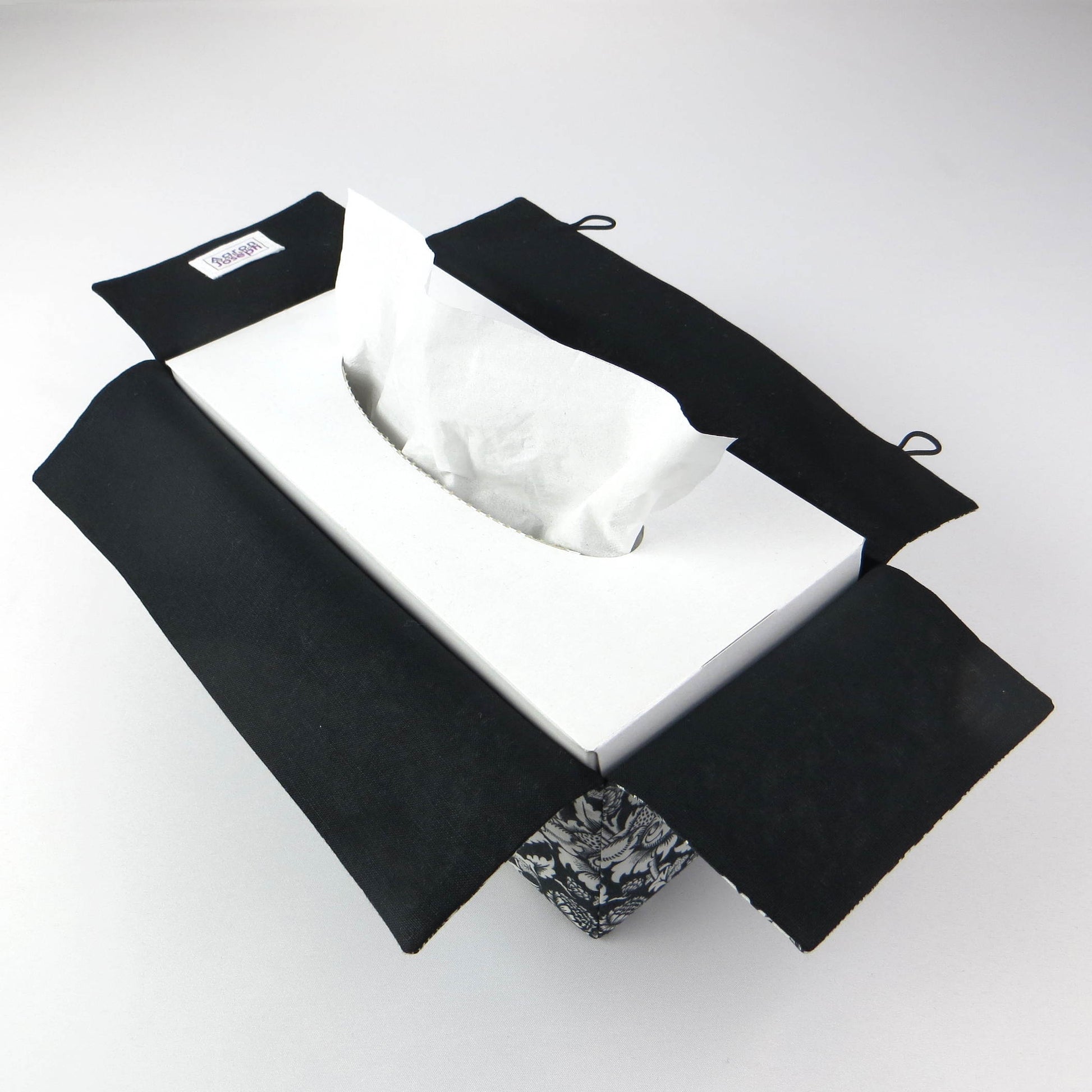 Rectangle tissue box cover with white flowering vine design on black background