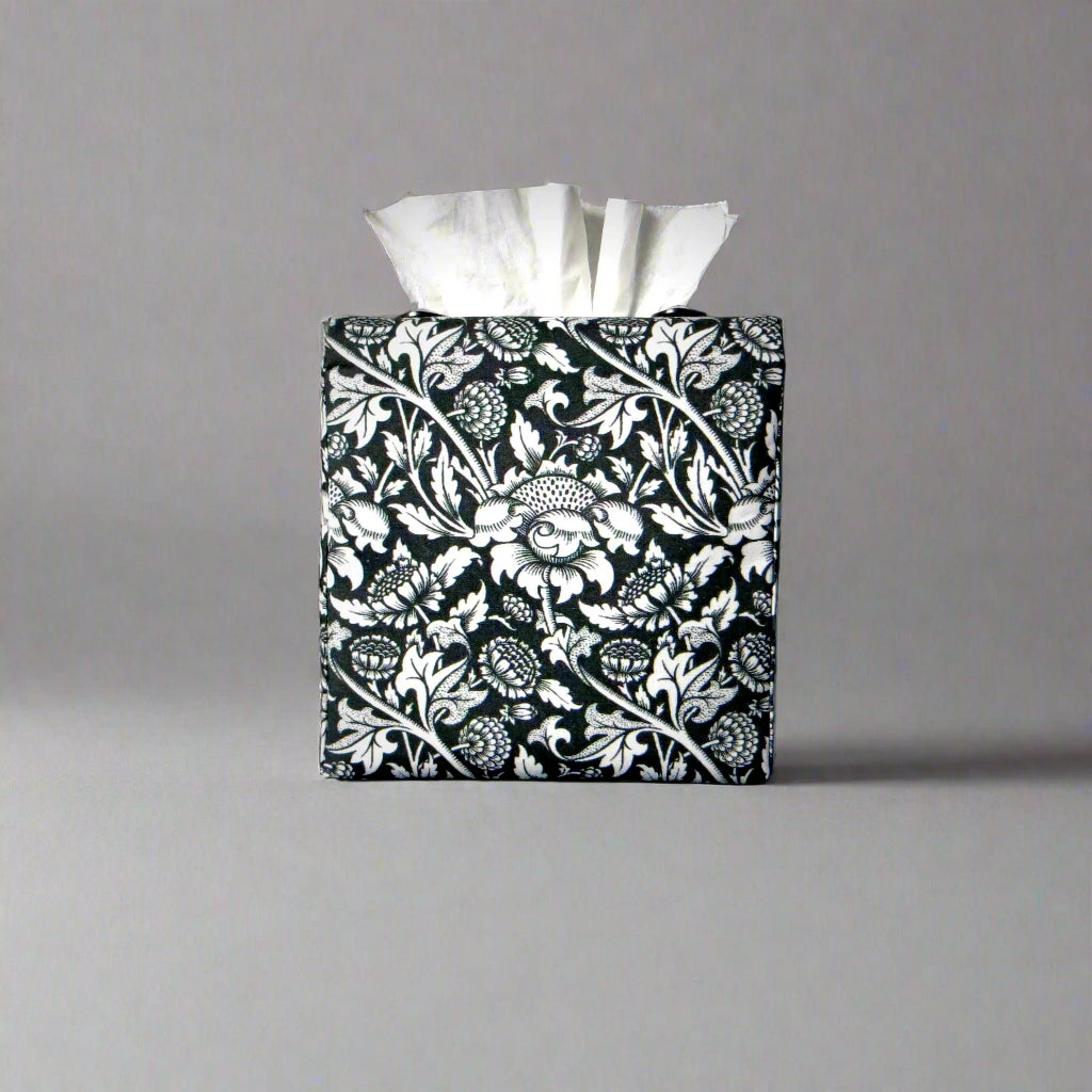 Square tissue box cover with white flowering vine design on black background
