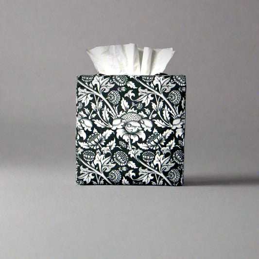 Square tissue box cover with white flowering vine design on black background