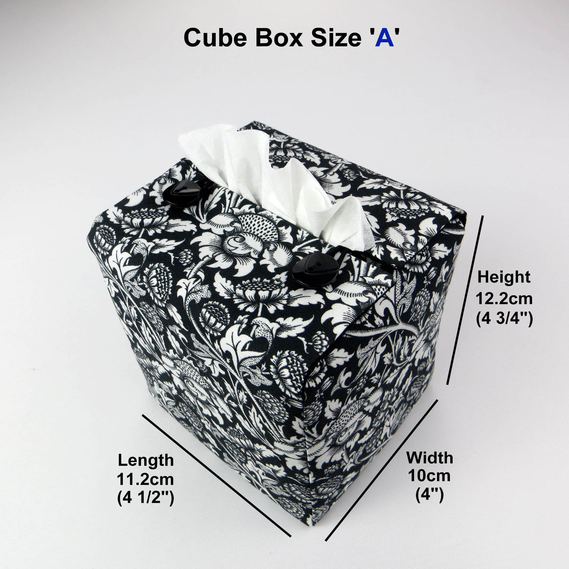 Square tissue box cover with white flowering vine design on black background