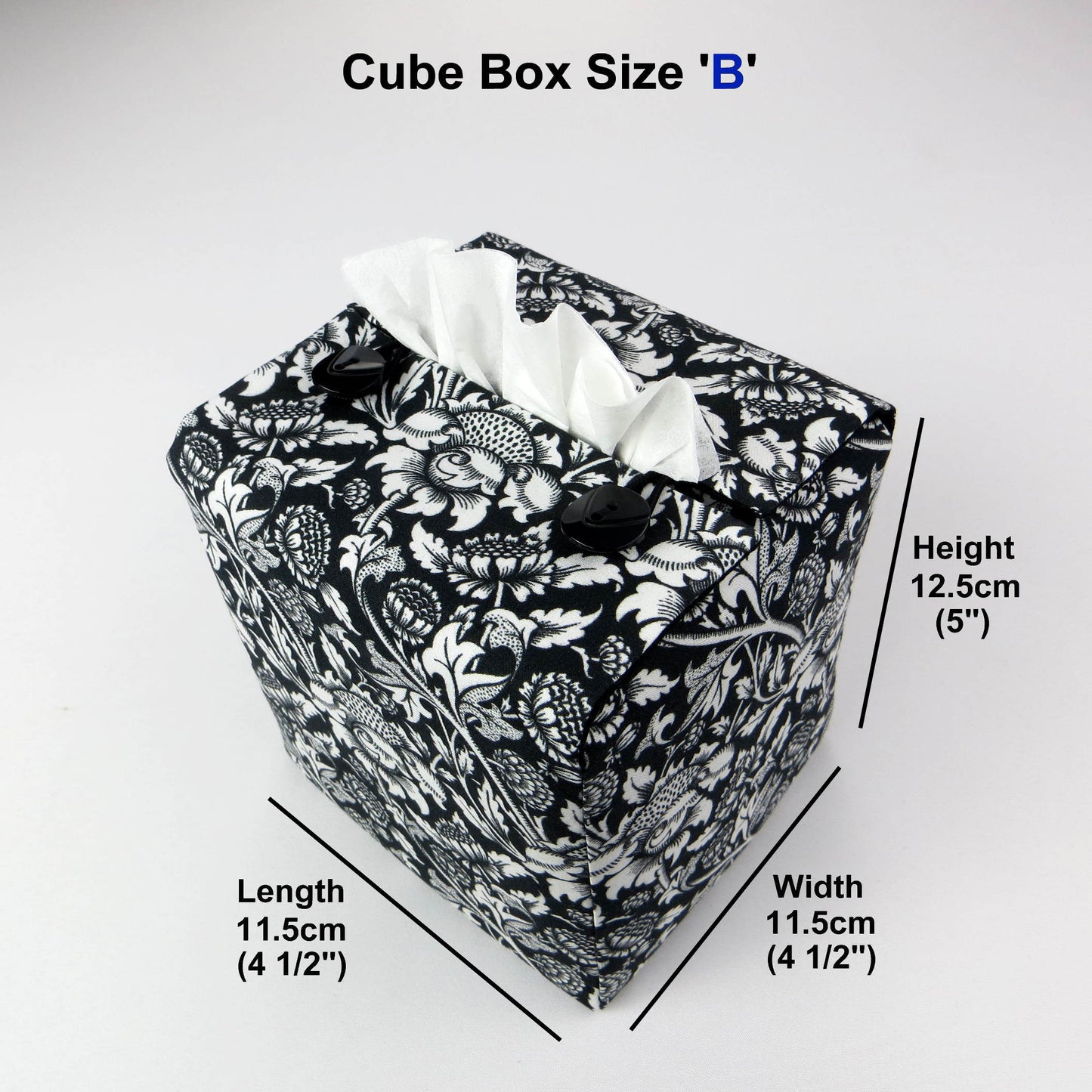 Square tissue box cover with white flowering vine design on black background