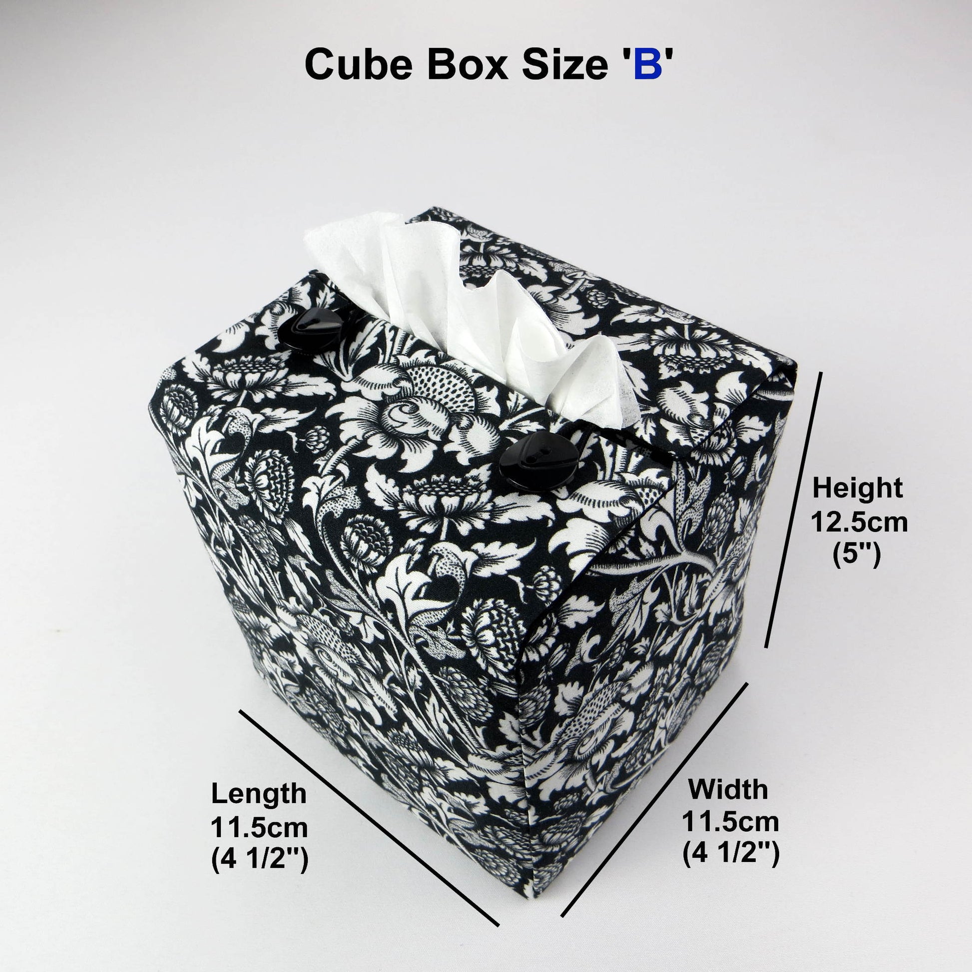 Square tissue box cover with white flowering vine design on black background