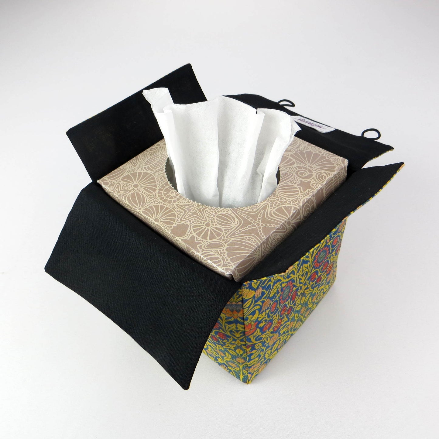 Cube tissue box cover with orange flowers and yellow vines design on blue background