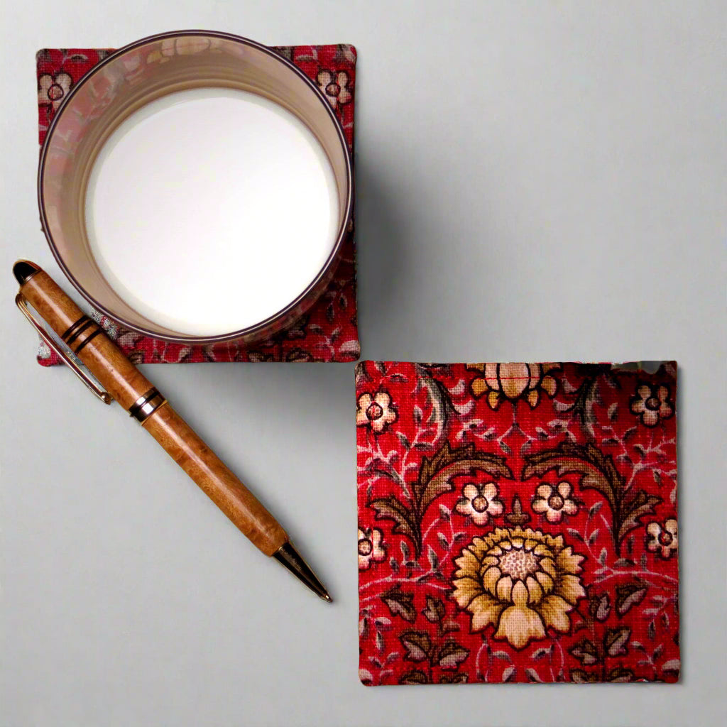 Square coasters with yellow and white flowers, and brown leaves on red background