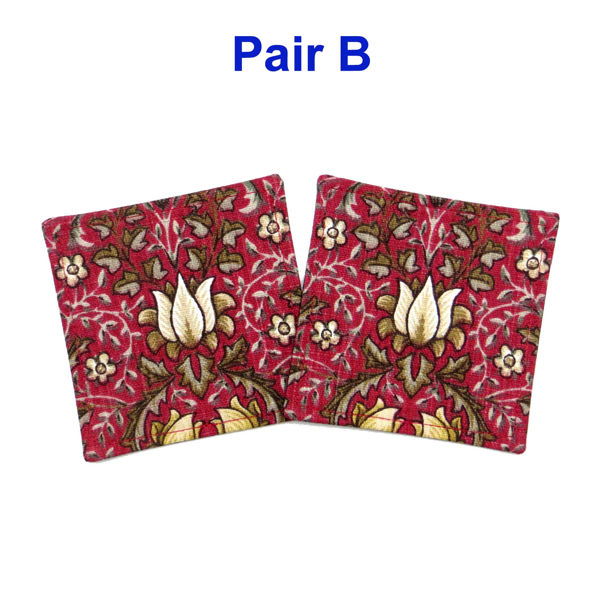 Square coasters with yellow and white flowers, and brown leaves on red background