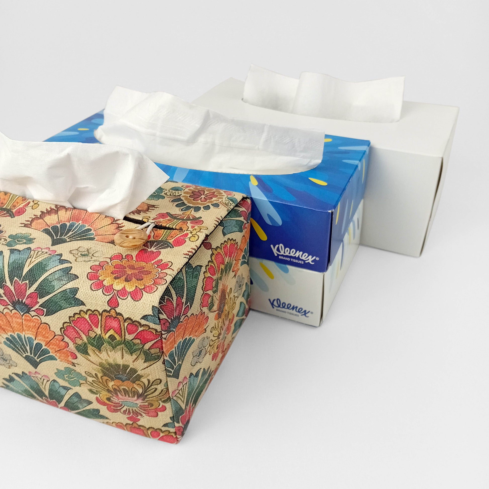 Linen tissue box cover with a colourful folding fan motif pattern on an antiqued tan background
