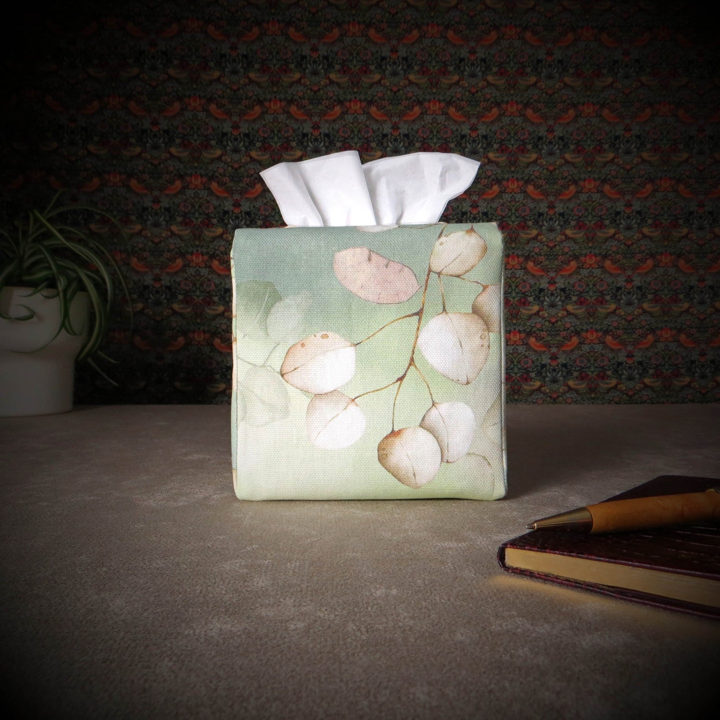 Printed cotton square tissue box cover with pen, notebook, and plant