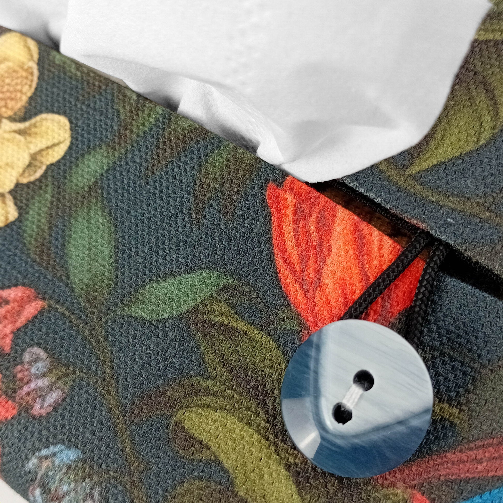 Linen tissue box cover with bright and colourful birds and flowers on a dark blue background