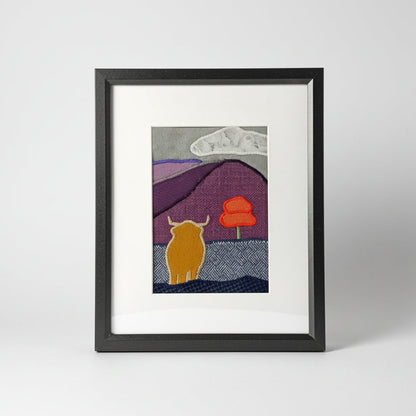 Framed fabric art with a highland cow and mountain image