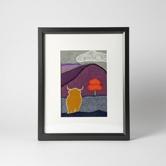 Framed fabric art with a highland cow and mountain image