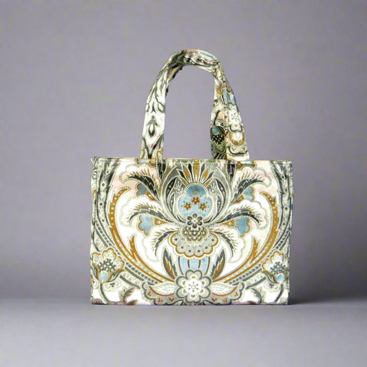 Small velvet tote bag with a floral design in blue, brown, black, and cream