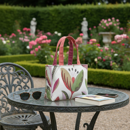 Small cotton tote bag with shades of moss green, raspberry pink, soft grey, and rhubarb red tulips on off-white background