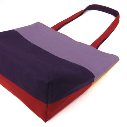 Bottom view of a large cotton tote bag with two vibrant colours on each side