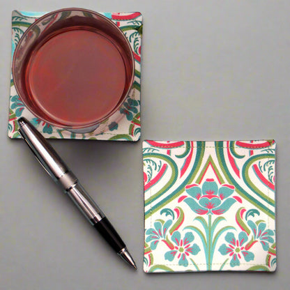 Set of 2 handmade coasters with blue flowers and elegant teal and red Victorian style accents on a white background