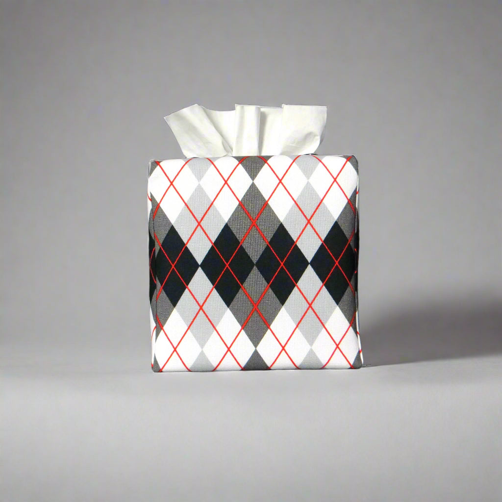 Square tissue box cover with black, grey, and red argyle pattern