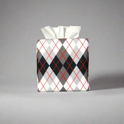 Square tissue box cover with black, grey, and red argyle pattern