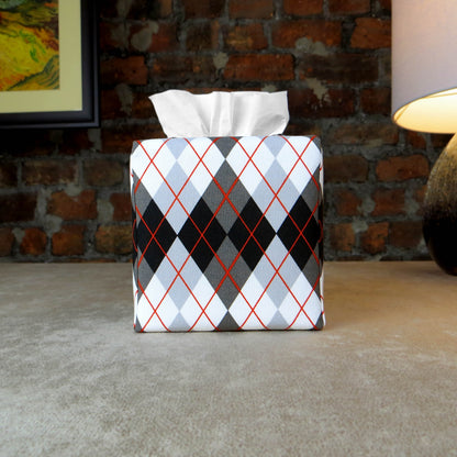 Square tissue box cover with black, grey, and red argyle pattern