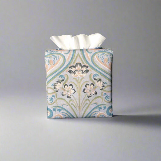 Square tissue box cover with charcoal grey and white flowers with blue, green and taupe Victorian embellishment on blue-grey background