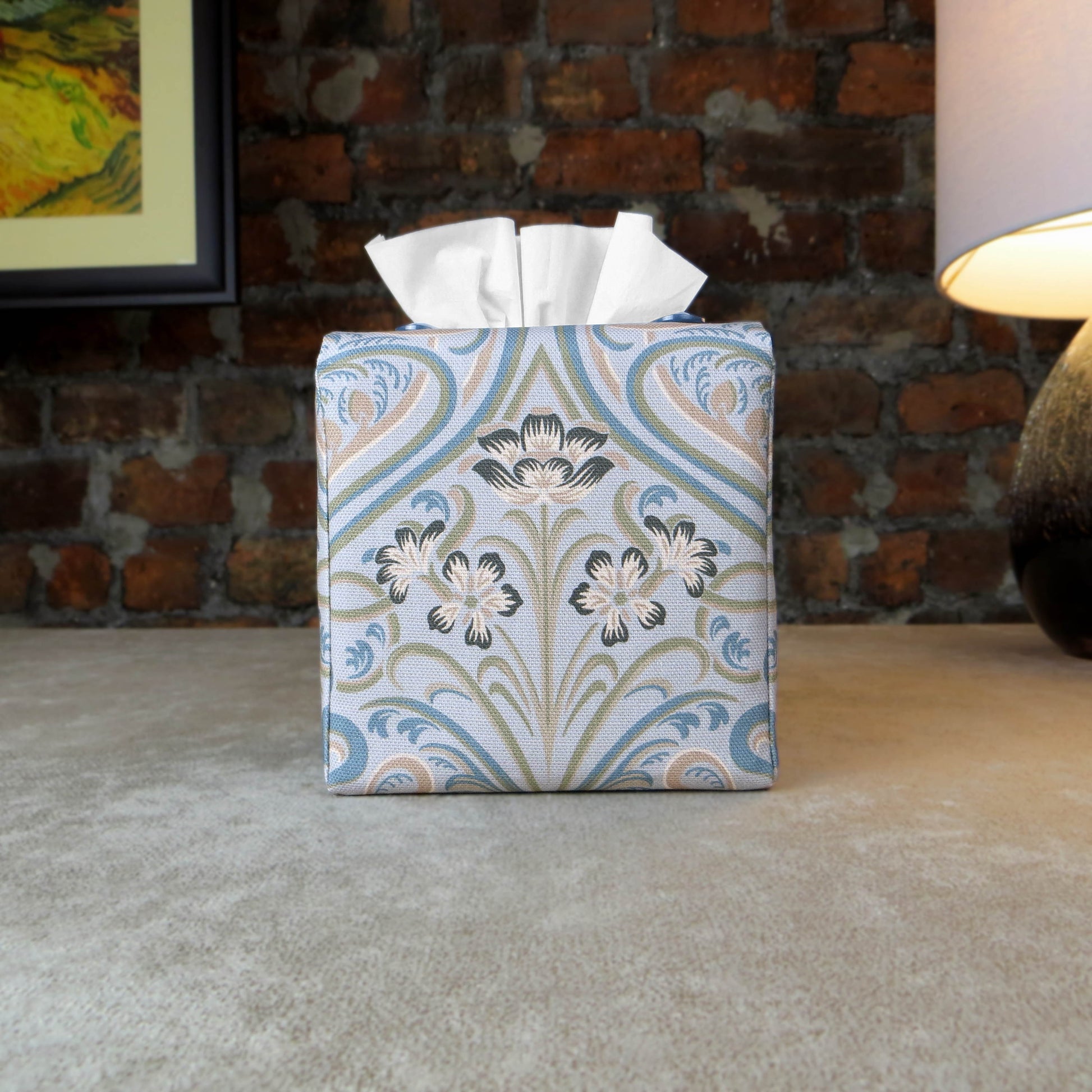 Square tissue box cover with charcoal grey and white flowers with blue, green and taupe Victorian embellishment on blue-grey background