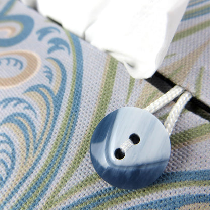 Rectangular tissue box cover with charcoal grey and white flowers with blue, green and taupe Victorian embellishment on blue-grey background