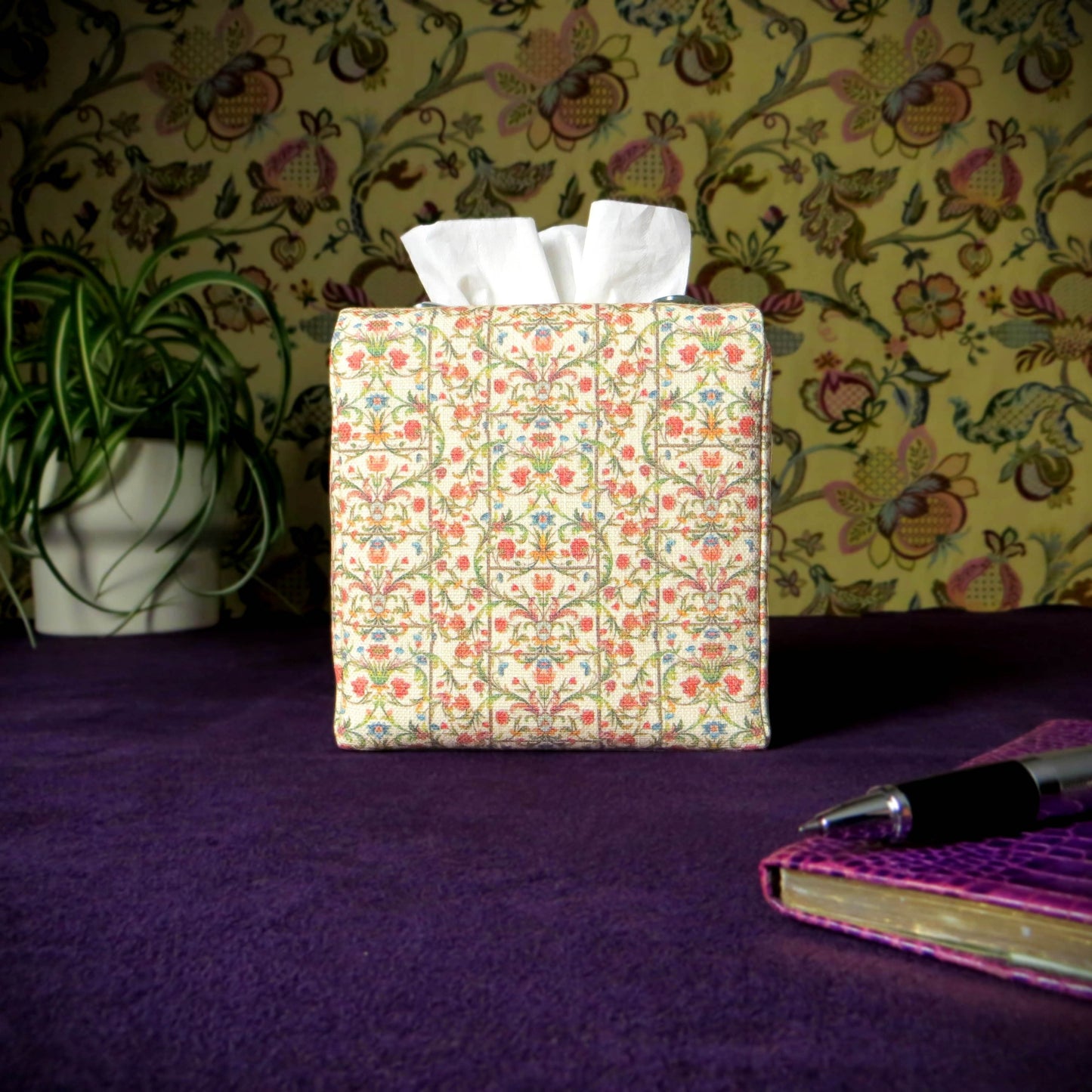 Linen square tissue box cover with pen, notebook, and plant