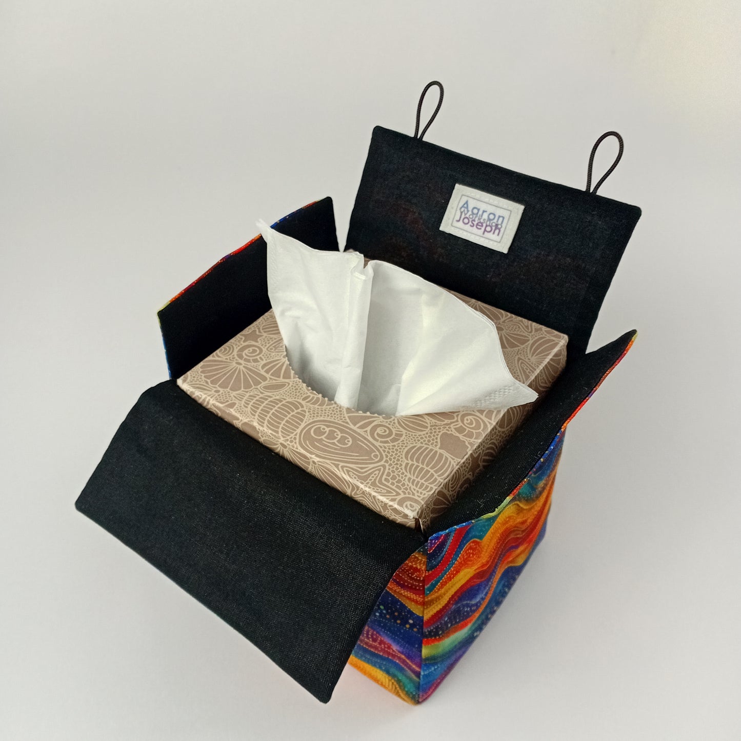 An interior view of a square tissue box cover with black lining