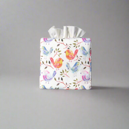 Cotton square tissue box cover with watercolour style blue, purple, and orange birds on white background