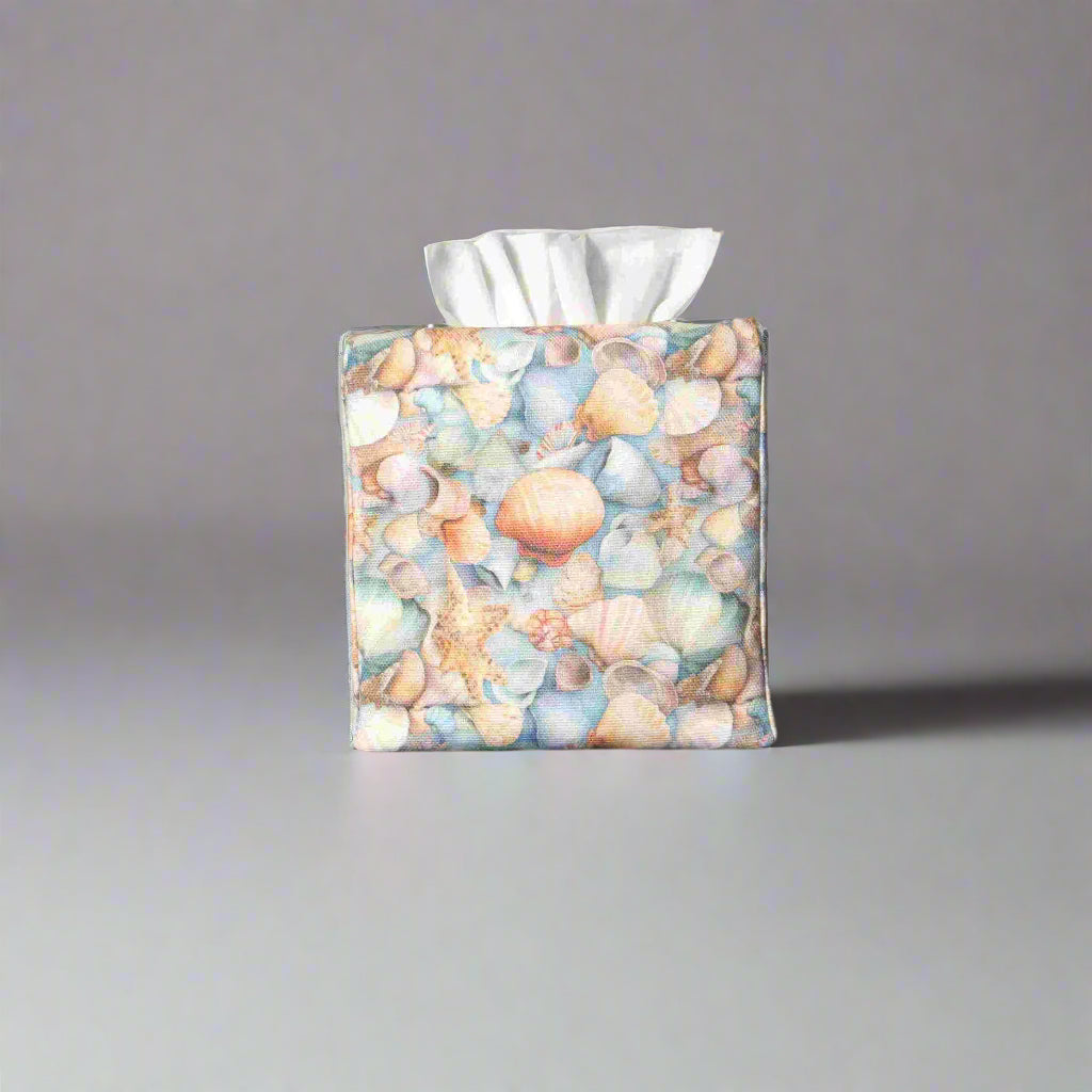 Cotton square tissue box cover with soft pastel seashell images set against a light blue background