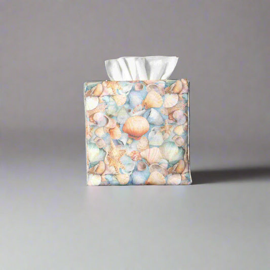 Cotton square tissue box cover with soft pastel seashell images set against a light blue background