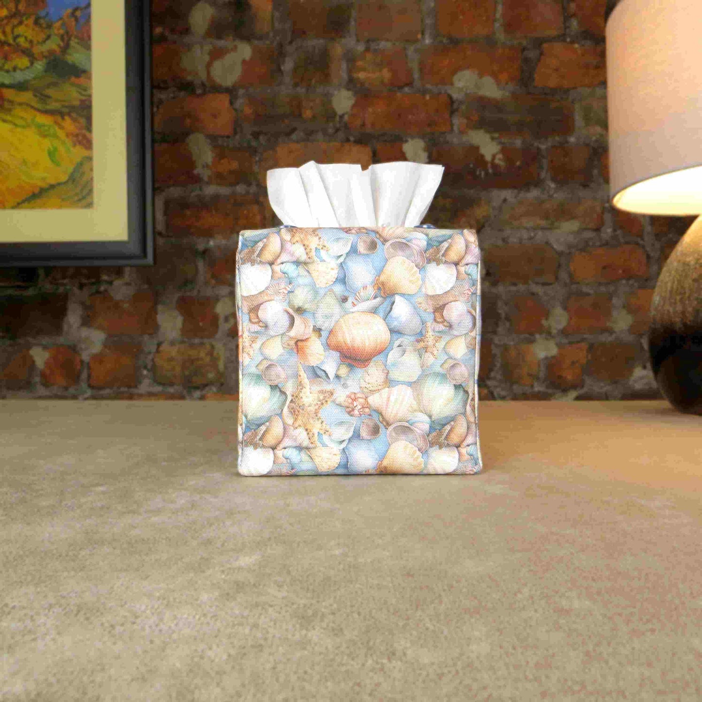 Cotton square tissue box cover with soft pastel seashell images set against a light blue background