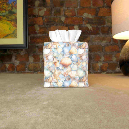 Cotton square tissue box cover with soft pastel seashell images set against a light blue background