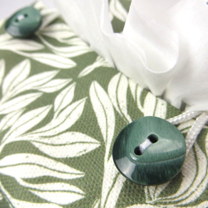 Linen square tissue box cover with an off-white leaf pattern on a sage green background