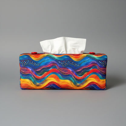A colourful wave pattern rectangular tissue box cover sitting on a grey background