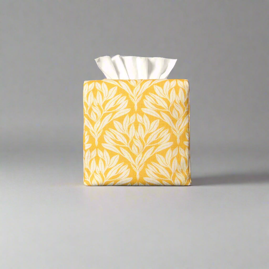 Linen square tissue box cover with an off-white leaf design on a yellow background