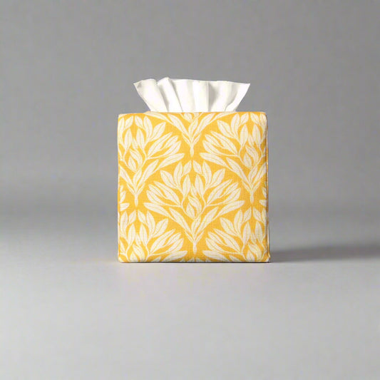Linen square tissue box cover with an off-white leaf design on a yellow background