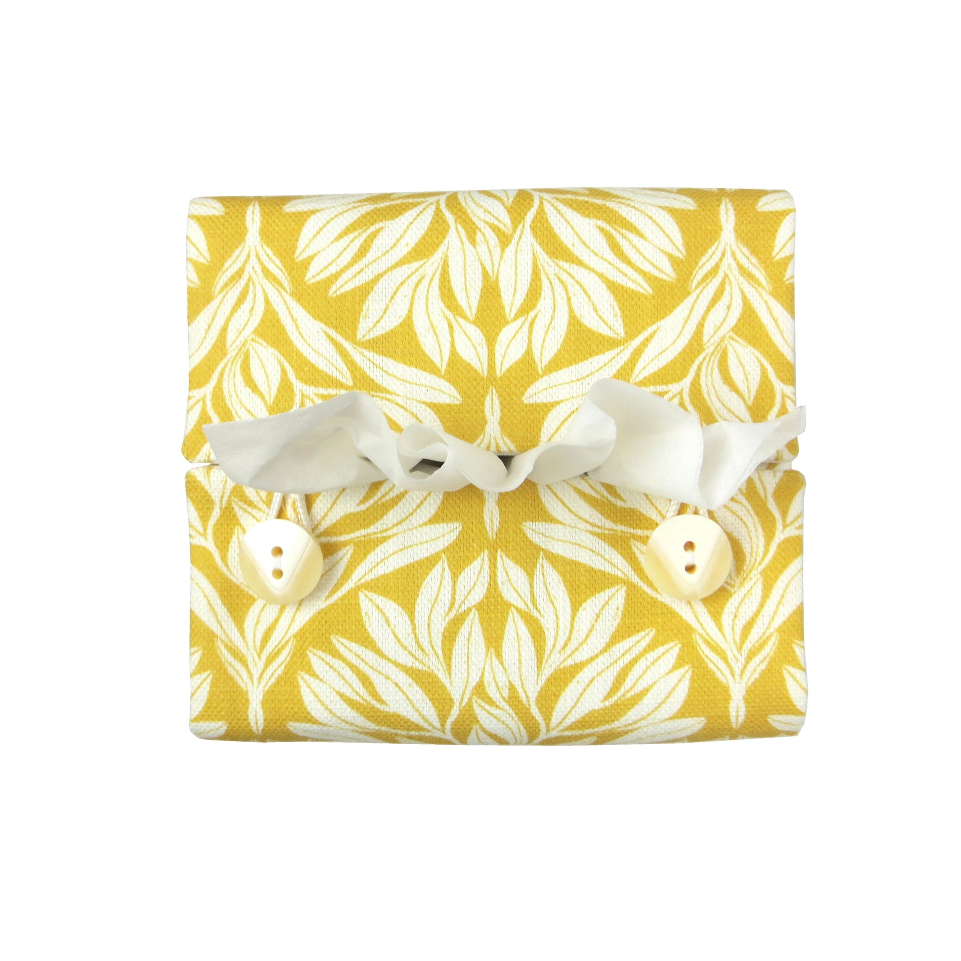Linen square tissue box cover with an off-white leaf design on a yellow background
