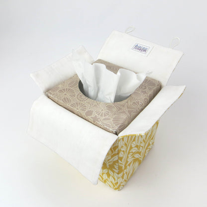 Linen square tissue box cover with an off-white leaf design on a yellow background