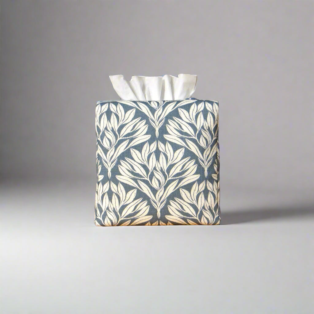 Linen square tissue box cover with an off-white leaf pattern on a blue background