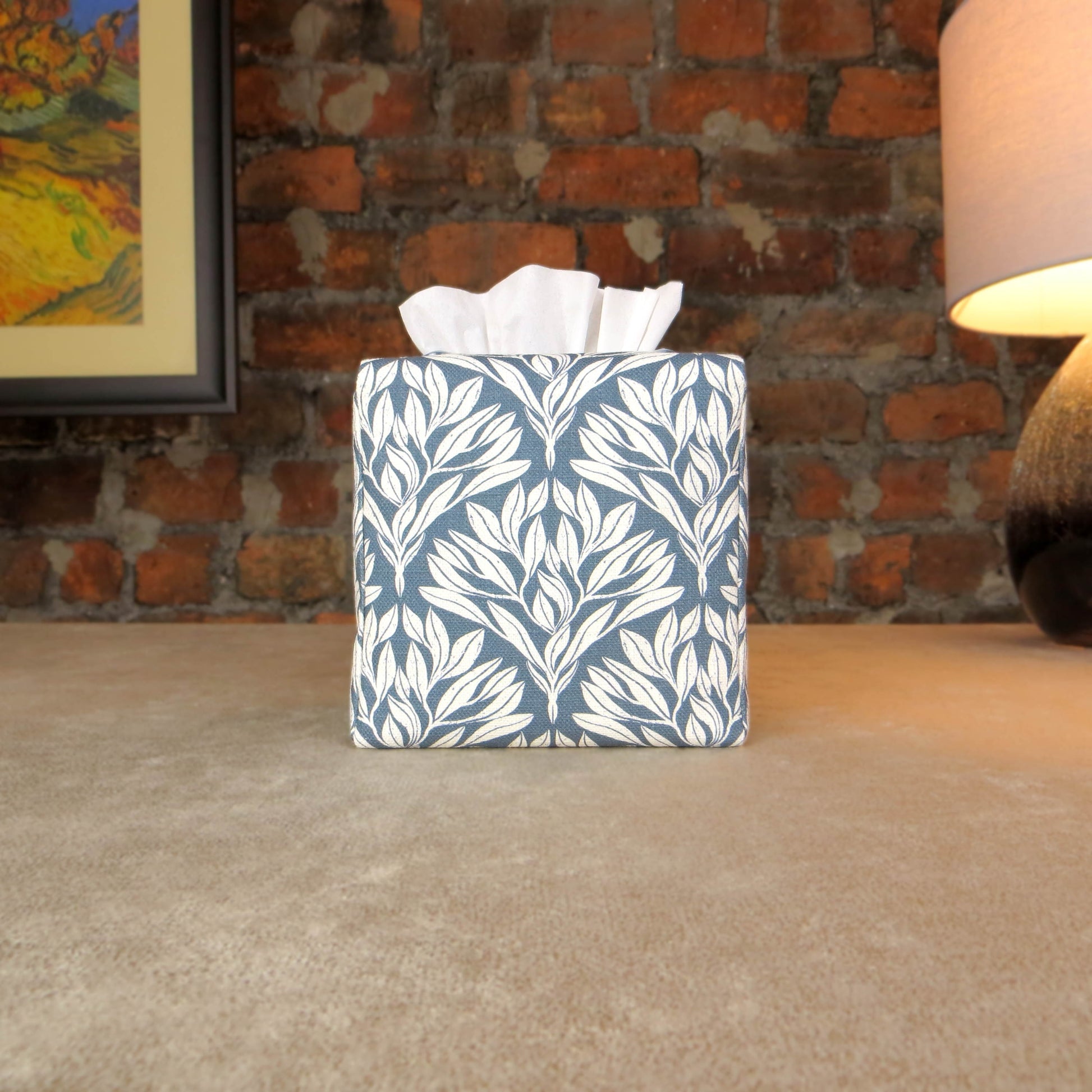 Linen square tissue box cover with an off-white leaf pattern on a blue background