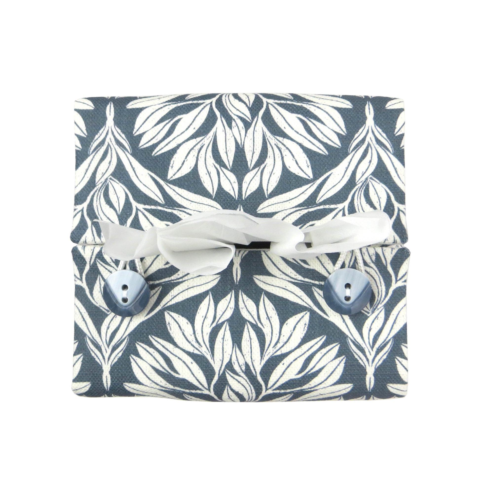 Linen square tissue box cover with an off-white leaf pattern on a blue background