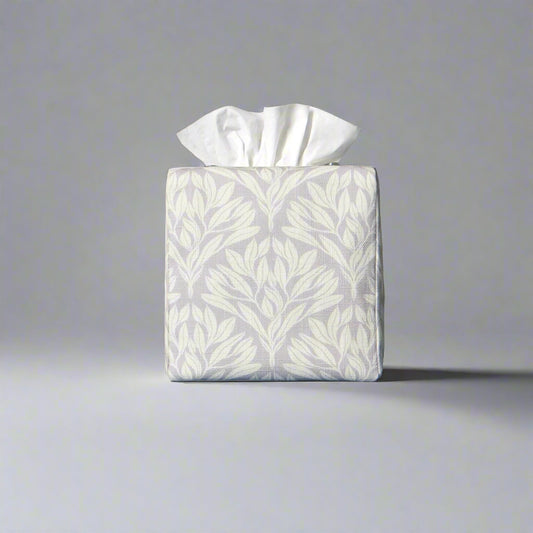 Square linen tissue box cover with off-white leaf design on a light grey background
