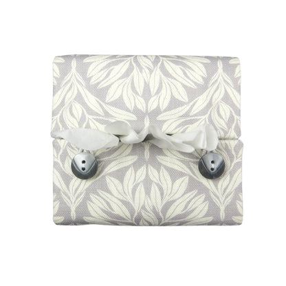 Square linen tissue box cover with off-white leaf design on a light grey background