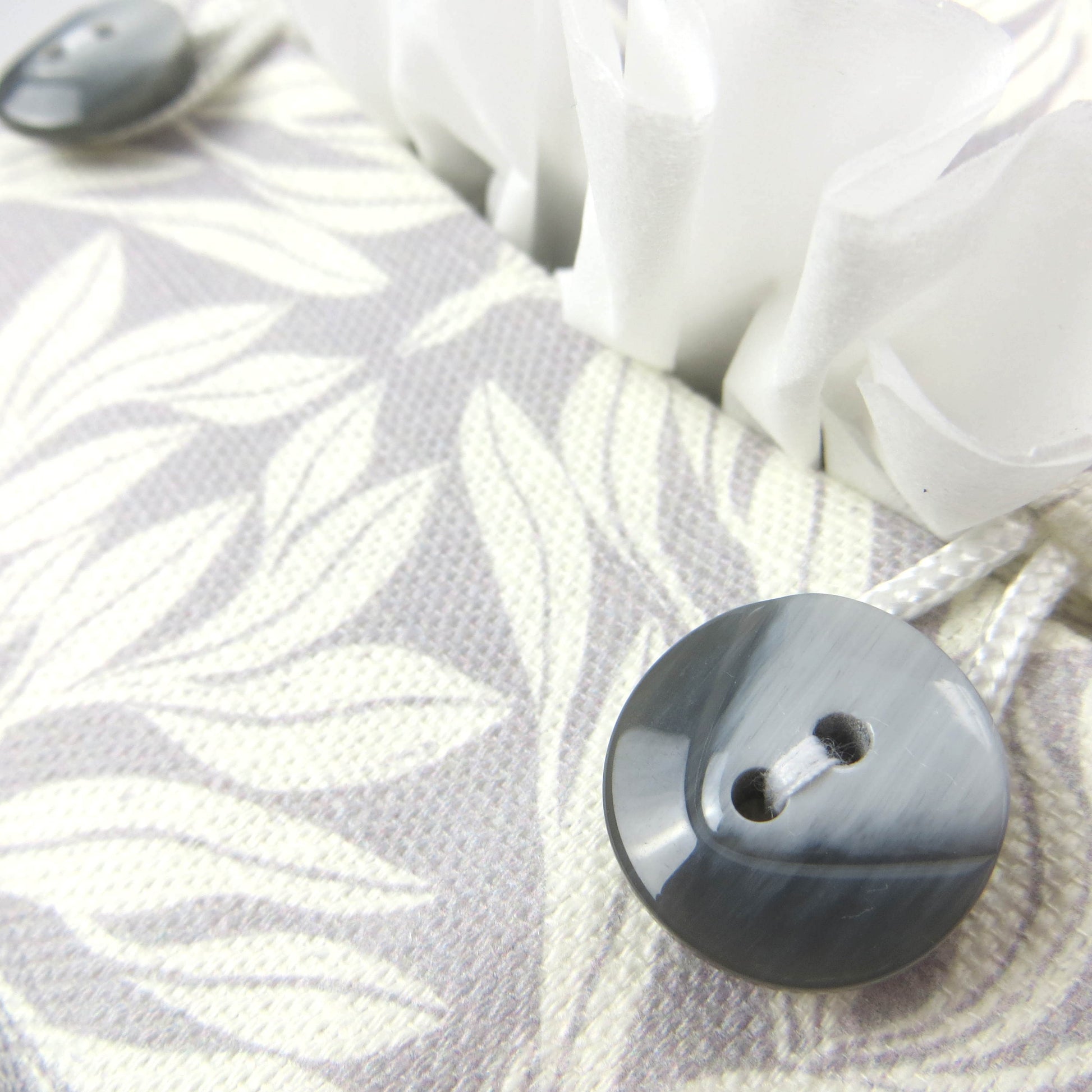 Square linen tissue box cover with off-white leaf design on a light grey background